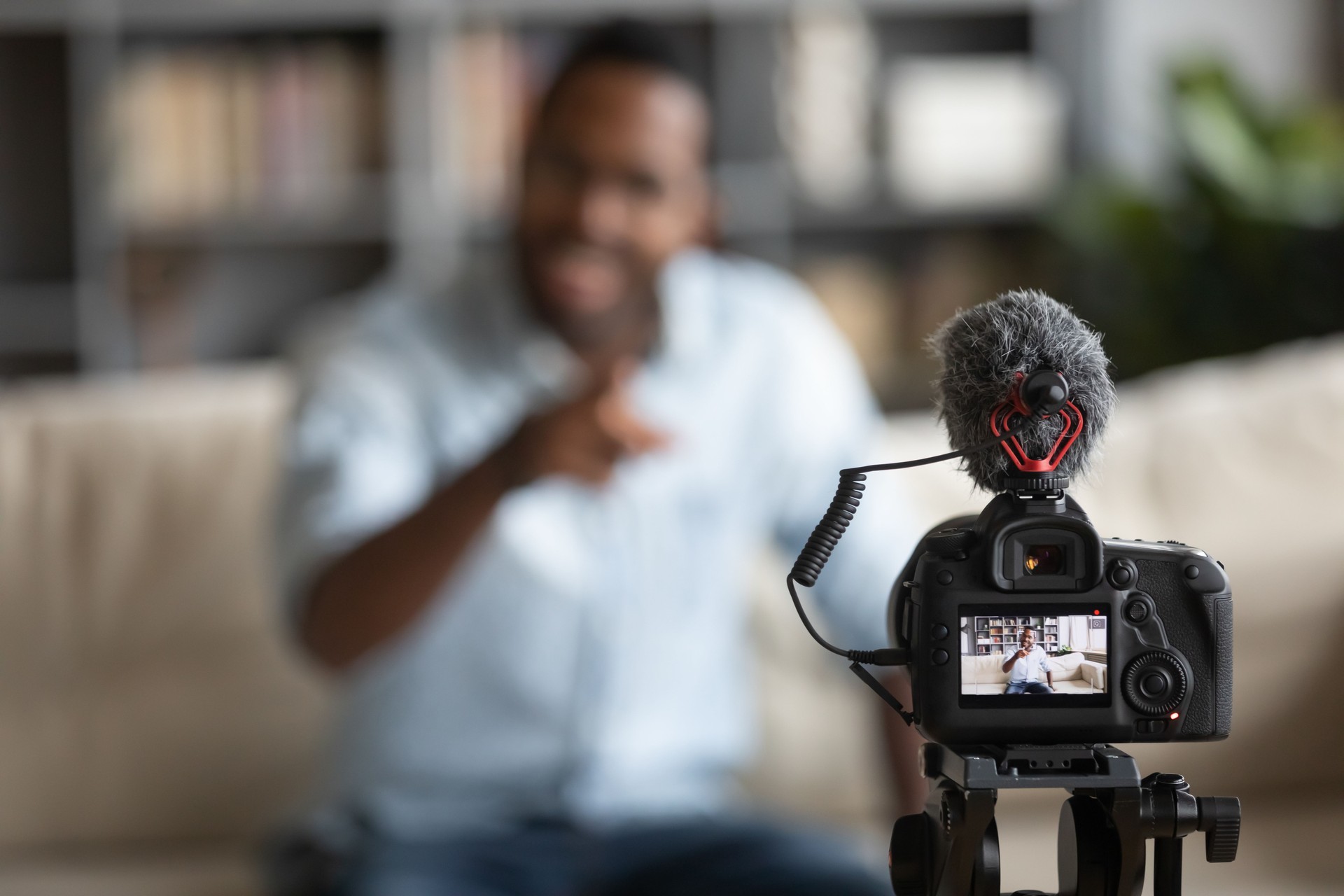 Close up African American blogger using digital camera, recording vlog